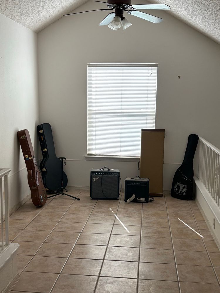 Three guitars, a banjo, and two amplifiers on the second floor of the house I am moving into 