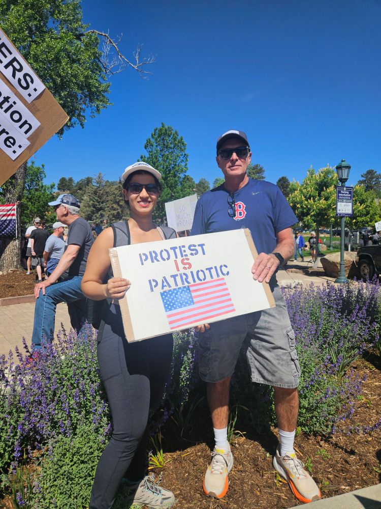 Pro democracy protest signs in the crowd