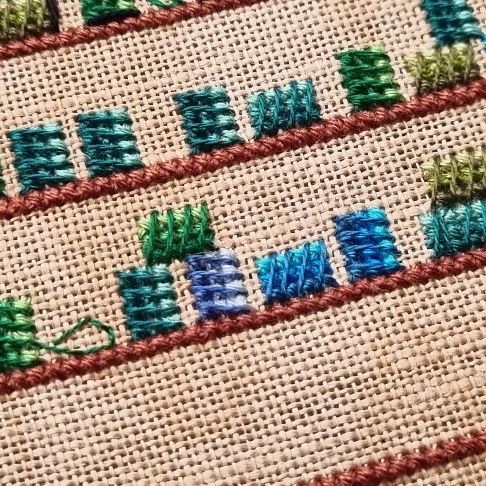 Cllse up of cross stitch shelves filled with colourful spools of thread
