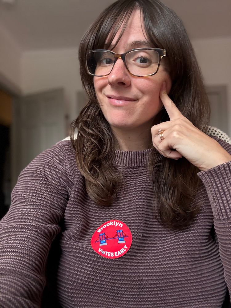 Me, a lady person, wearing the exciting “Brooklyn Votes Early” sticker that heavily features the Brooklyn Bridge, a classic beloved by all.