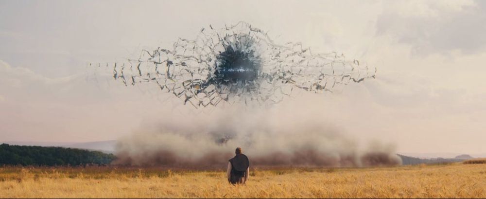 An eye shaped tear in the sky, colored black, appears to be like tearing the fabric of reality. A man, Rand al’Thor inhabiting the body of his ancestor, stands in field below looking up at the terror being unleashed before him