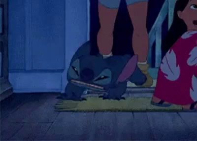 stitch from disney 's lilo and stitch is standing on a wooden floor eating pizza .