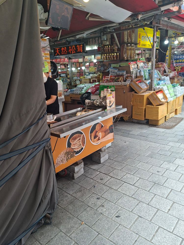 A market stall in Namdaemung market in Seoul, Korea where they sell said psncakes and corn dogs.