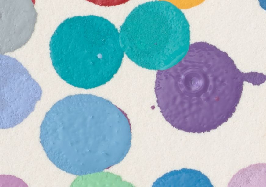 A close up of small dots painted on handmade paper.