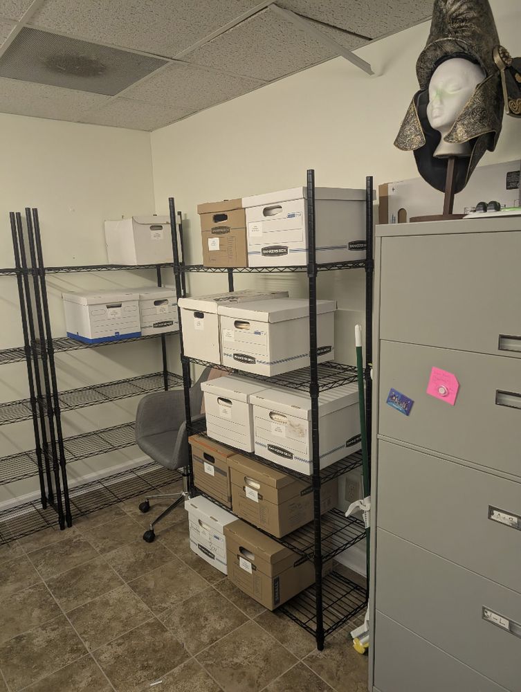 Image of boxes stacked on metal shelving. 