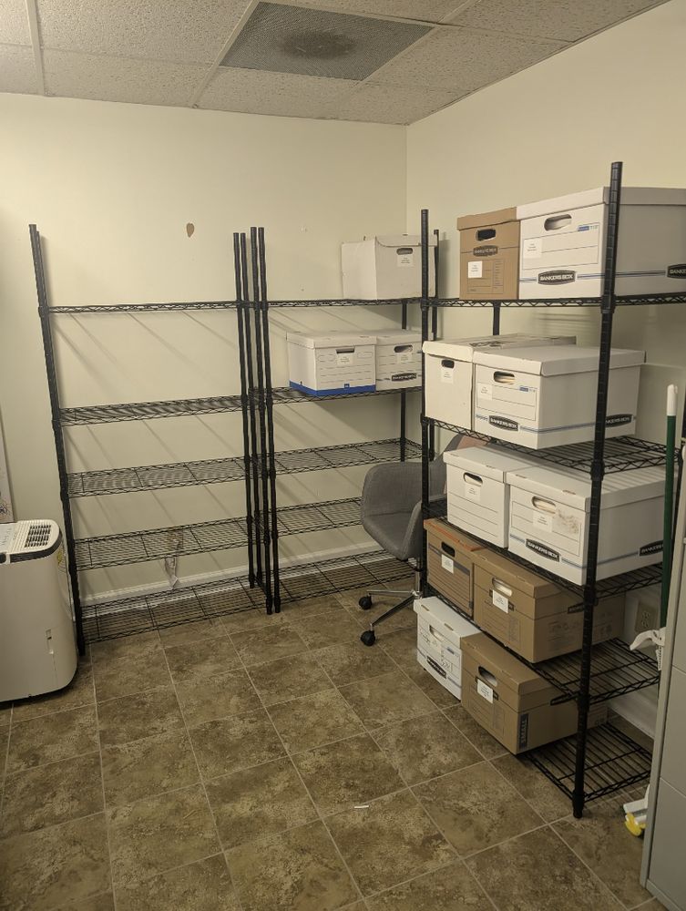 Image of boxes stacked on metal shelving. 