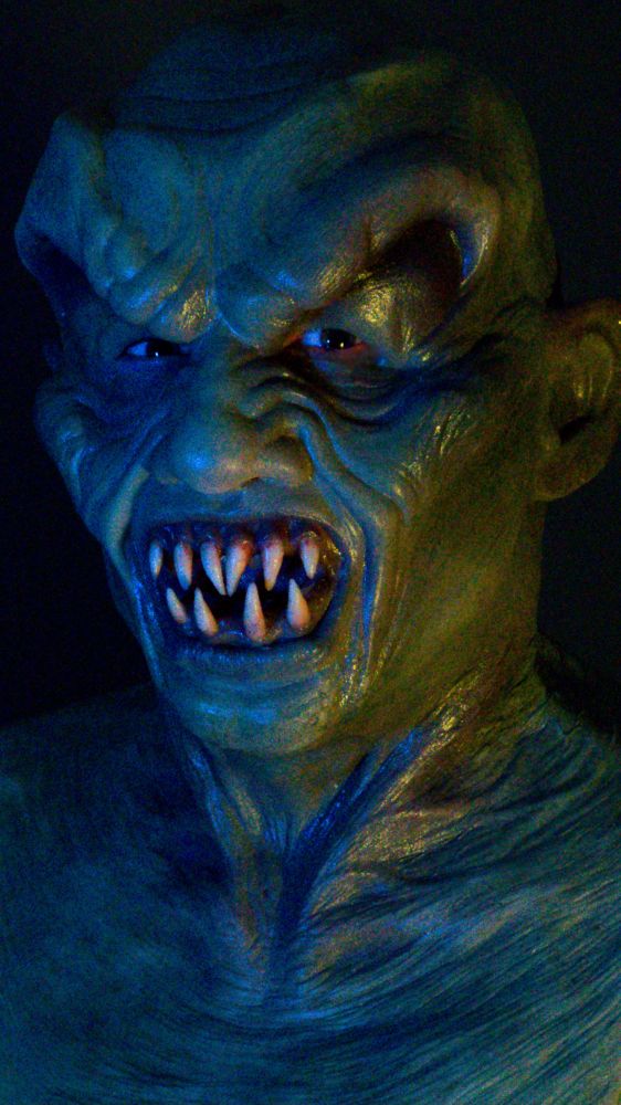 A man posing in a silicone mask.