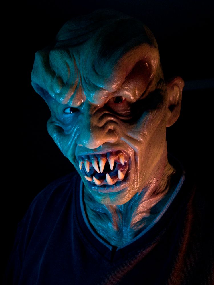 A man posing in a silicone mask.