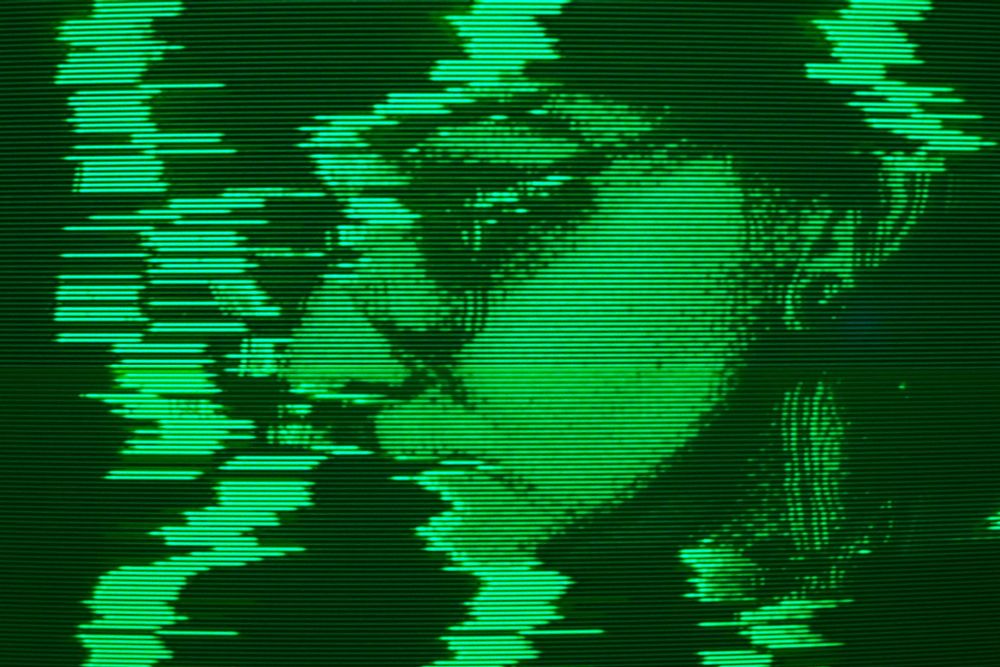 side profile shot of me on a green CRT with some light glitching
