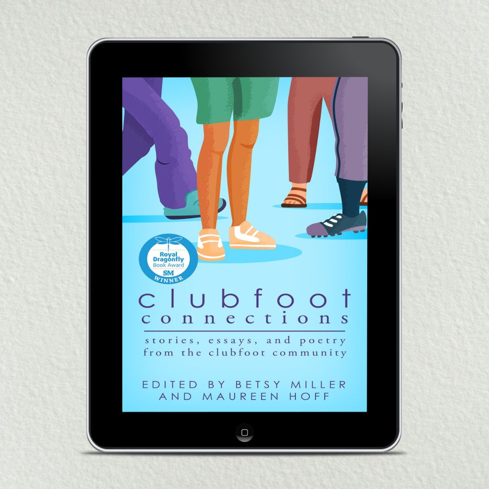 A tablet shows the book cover for Clubfoot Connections: Stories, essays, and poetry from the clubfoot community.