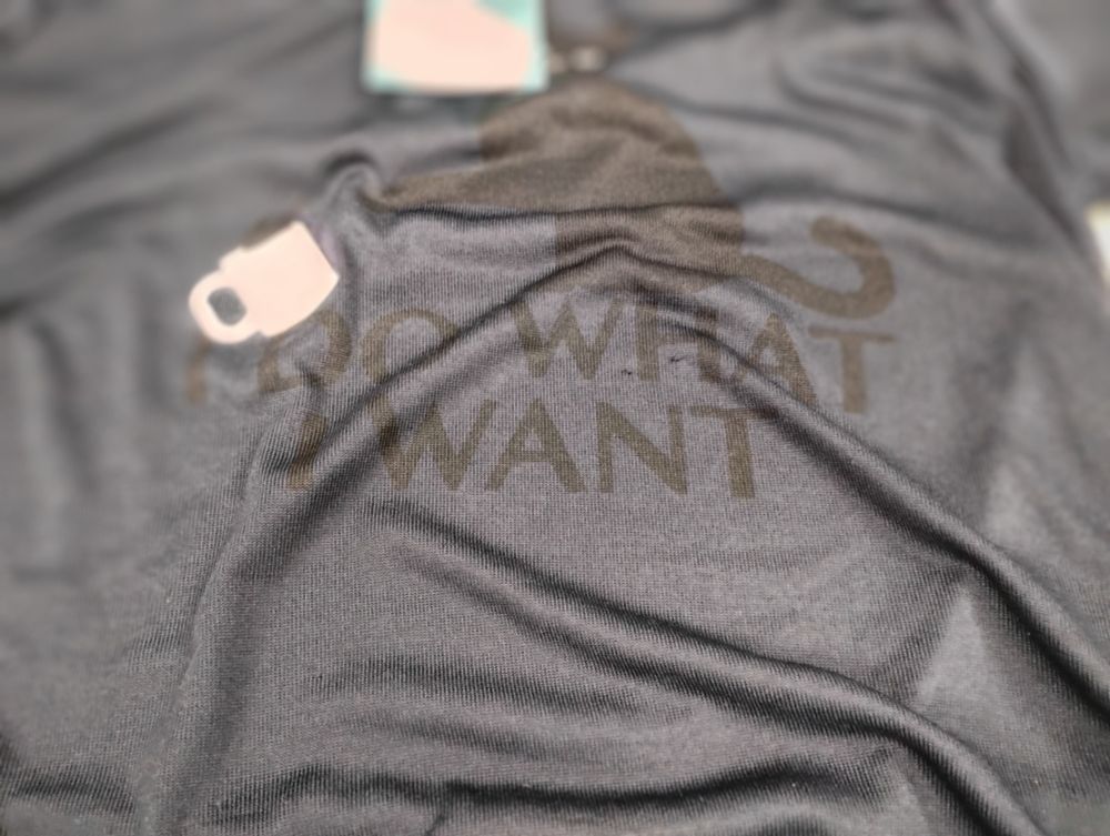 A hoodie with a picture of a cat knocking over a mug. There is text on the hoodie that says "I do what I want".