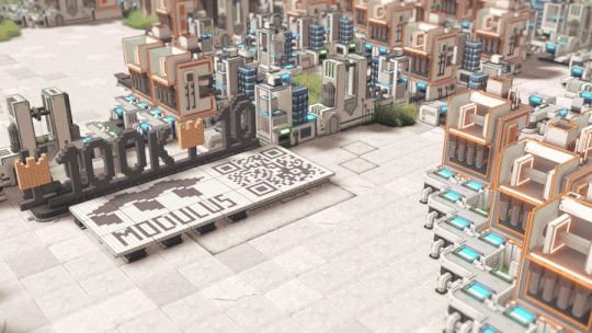 A factory set up in the game Modulus, with modules arranged to looks like 100K and a crown going round on a conveyor belt. 
