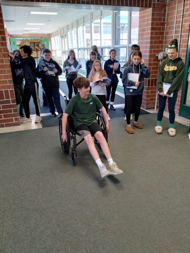 Male student trying to navigate in a wheelchair.