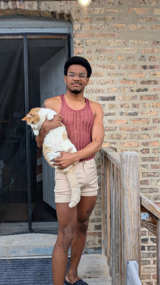 Me in a mesh lace tank top holding a cat
