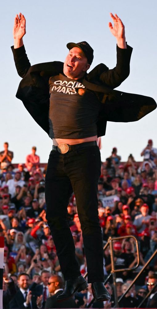 Elon Musk awkwardly jumping in the air at a Trump rally.