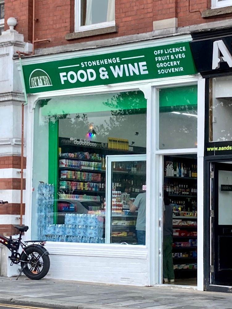 A shop front with the sign ‘Stonehenge Food & Wine’ and a logo of the monument 