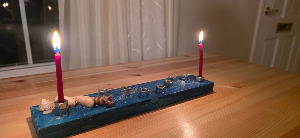 A Hanukkiah with two candles in burning.
