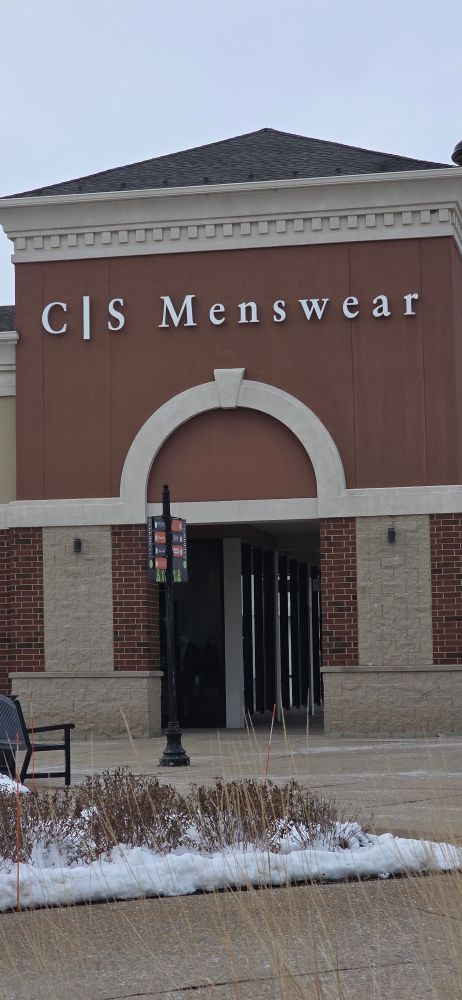A brick storefront that is labeled C|S Menswear 