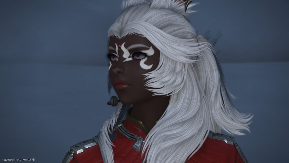 A screenshot of Oro, a female Viera with dark skin and white hair. She gazes away from the camera with a serious expression.