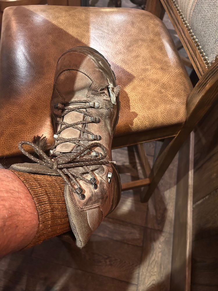 A photo of one of my very battered walking boots. Falling apart.