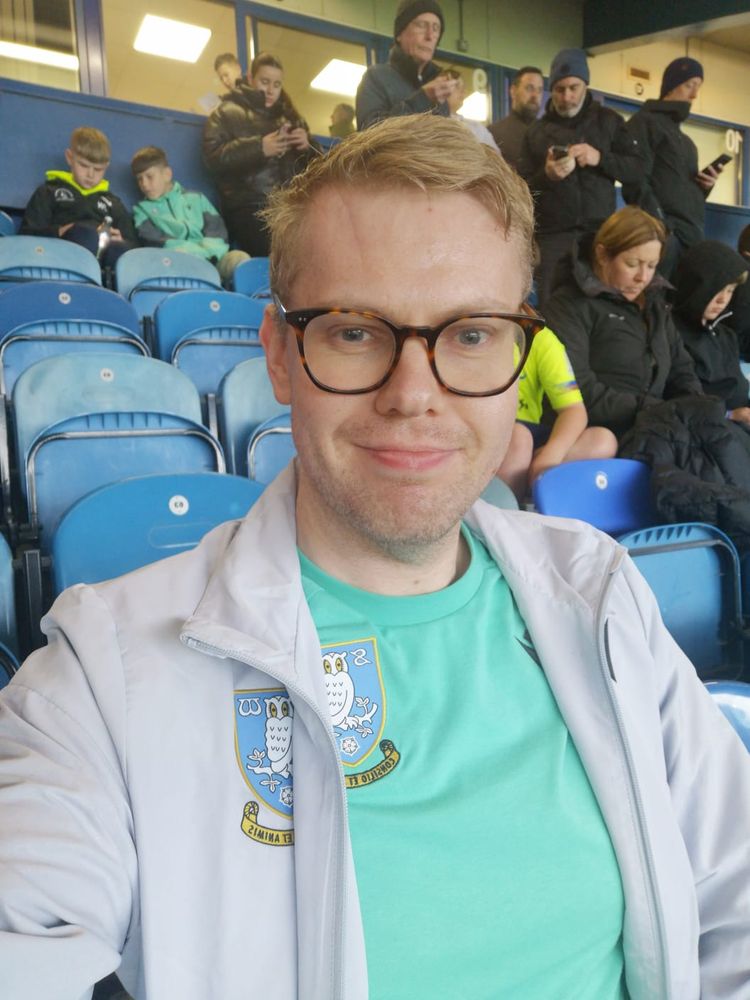 A selfie of me wearing a grey SWFC jacket and green SWFC training stop at Hillsborough Stadium.