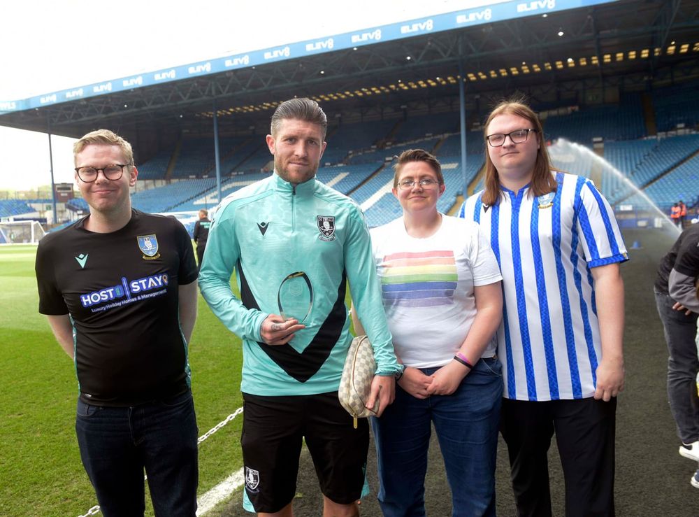 A photo of me and two Rainbow Owls members presenting Josh Windass' Player of the Season trophy to him pitchside at Hillsborough Stadium.