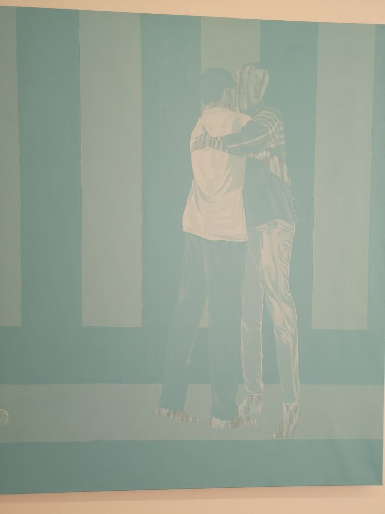 A painting of two men hugging from the The Blue Between Us exhibit at Rele Gallery.