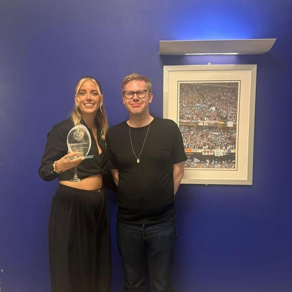 A photo of me handing a Player of the Season trophy to Eleanor Vessey at Sheffield Wednesday Ladies FC's awards presentation evening.