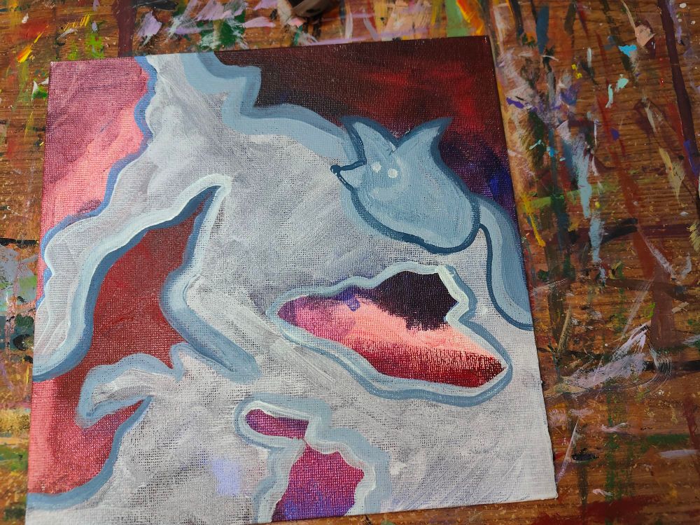 Abstract painting done in deep reds and light blues. There is a portion outlined in darker blue that looks like a little fox among the light blues