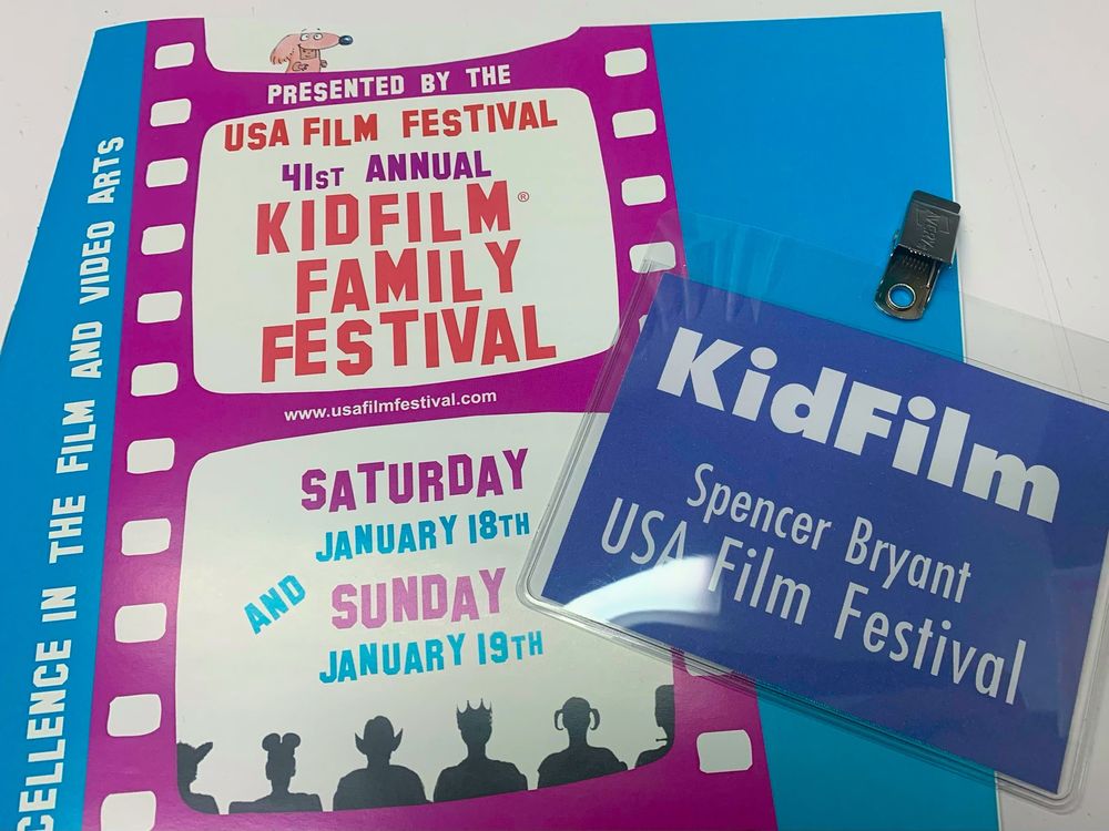 the “kid film” flyer and a “kid film” badge with my name on it 