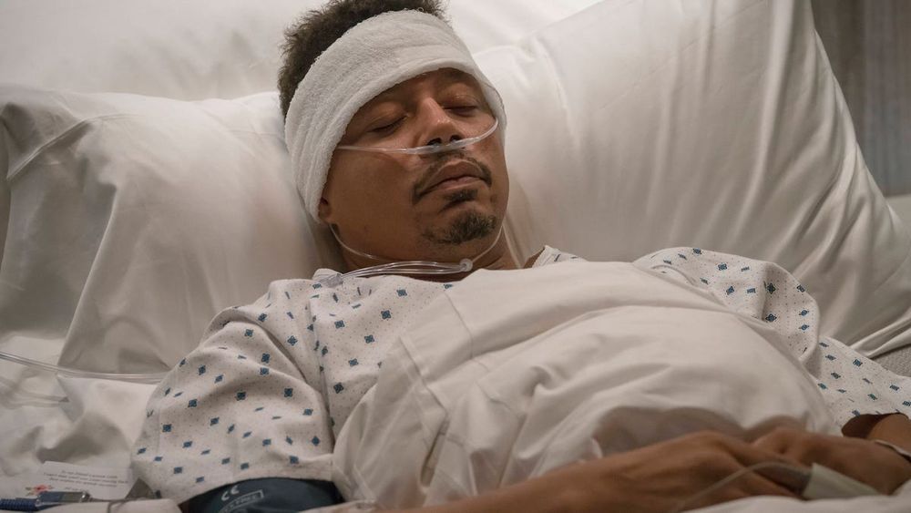Terrance Howard in Empire, laying in a hospital bed with his head bandaged and an oxygen tube.