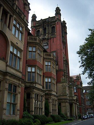 Exterior view of Armstrong Building, Newcastle University, red brick, neo-Gothic-ish architecture with many windows.