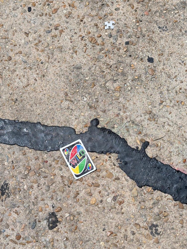A Wild card from UNO on the ground. 