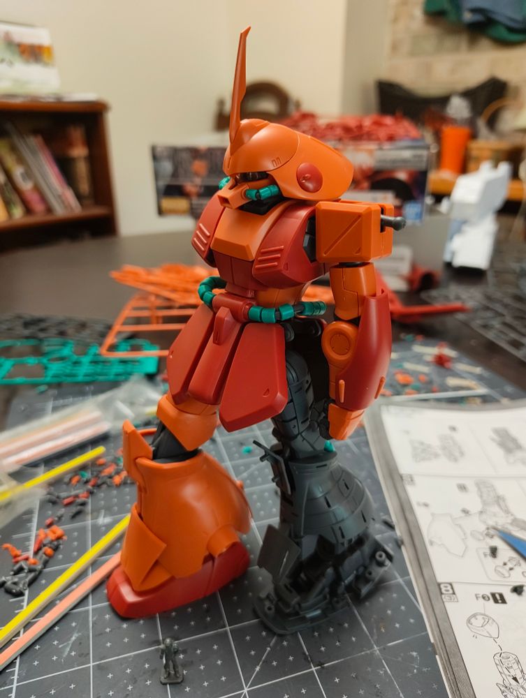 A 1/100 scale MG Marasai Gunpla, about 2/3 assembled. Its left leg has been built without armor, showing off the faux-mechanical infrastructure.