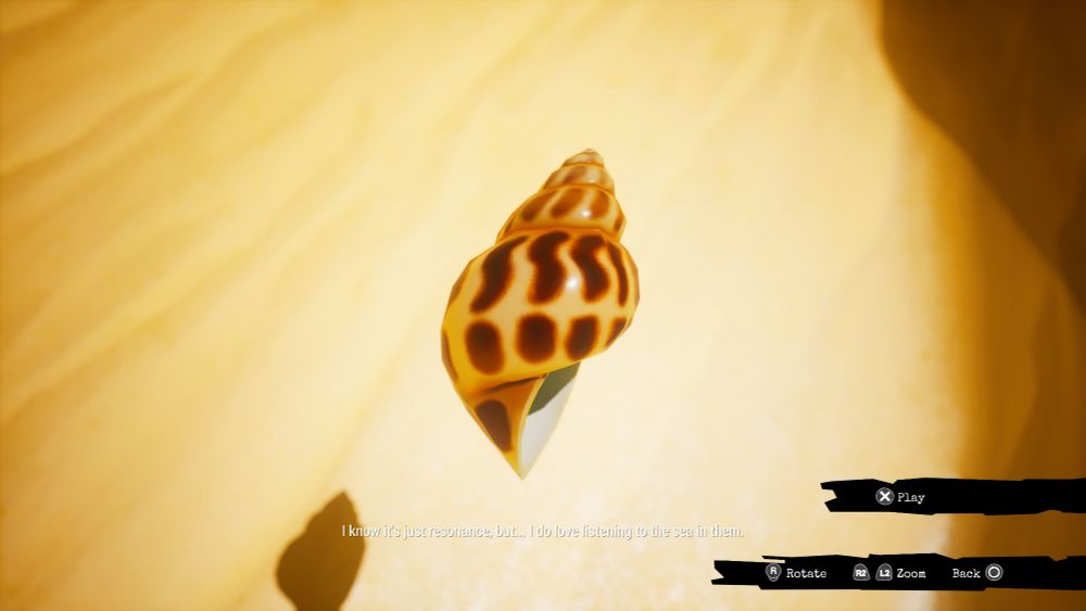 Screenshot from the video game Call of the Sea showing a shell on yellow sand with white subtitles. The subtitles are hard to see.