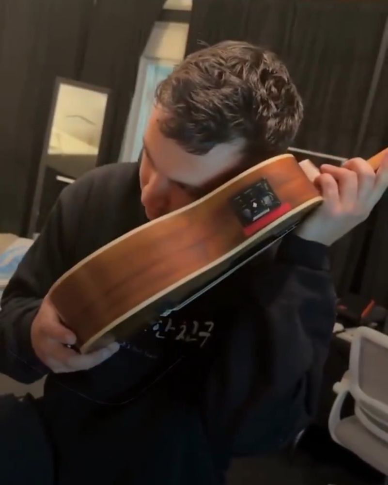 Tyler is talking to the ukulele as it's a phone. As someone does