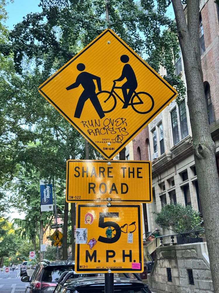 Street sign warning and speed limit for bicycles and e-bike riders. Instructions on how to deal with racist walkers. Run over racists.