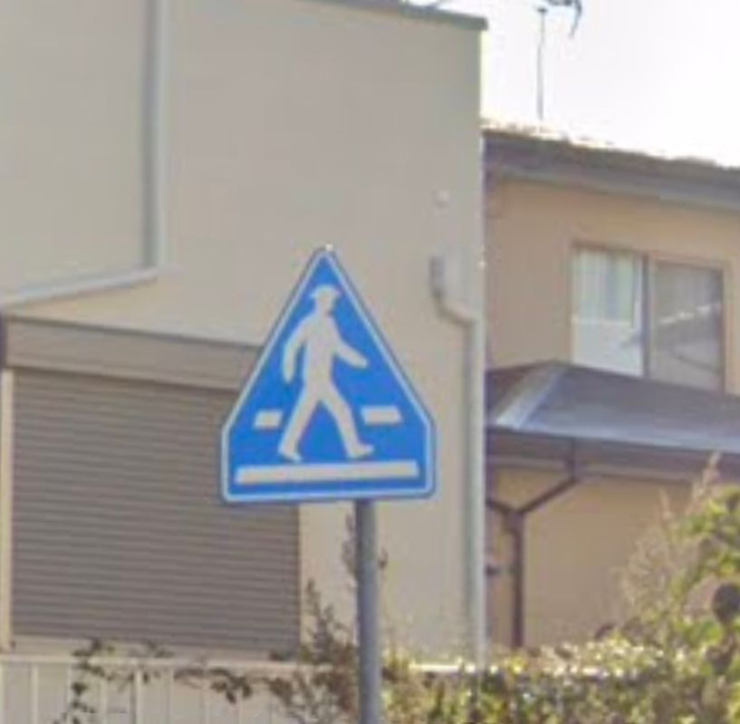 Geoguessr screenshot of a crosswalk somewhere in Europe where the guy has a hat on