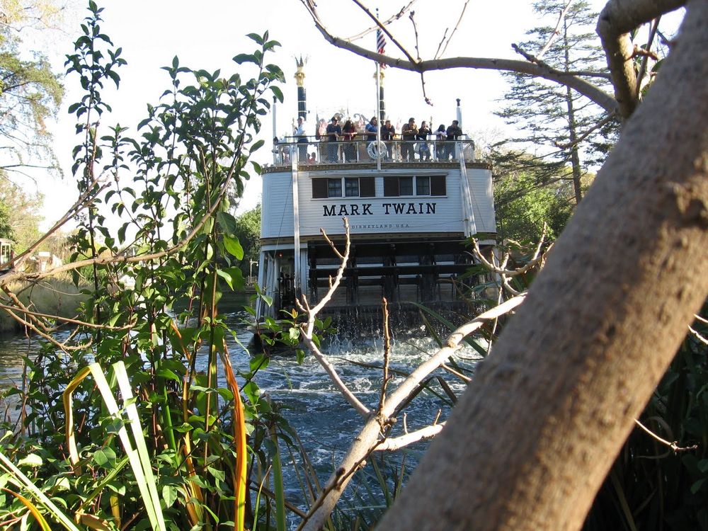 Disneyland Mark Twain Steamboat hiding behind the trees and bushes of Tom Sawyer Island. 