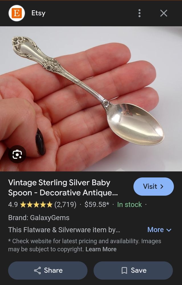 an etsy listing for a vintage sterling silver baby spoon. It is barely larger than the model's four fingers.