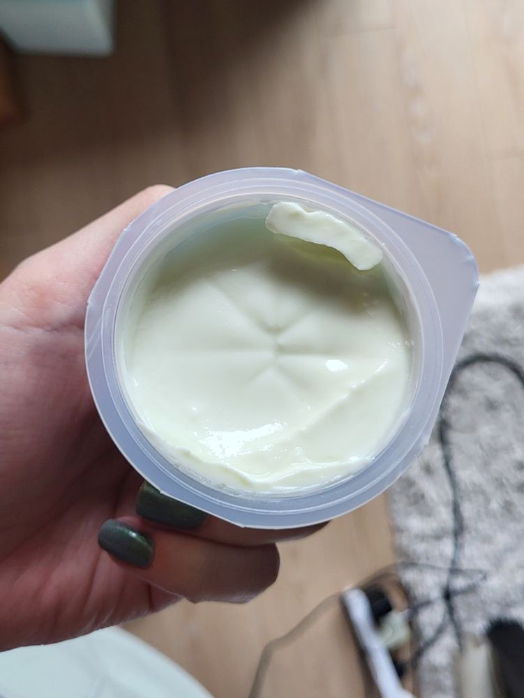 a cup of yogurt that has a puckered butthole.