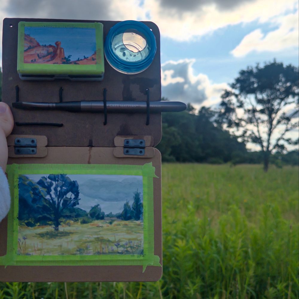 My mini painter palette with a painting of a backlit tree in a prairie. 