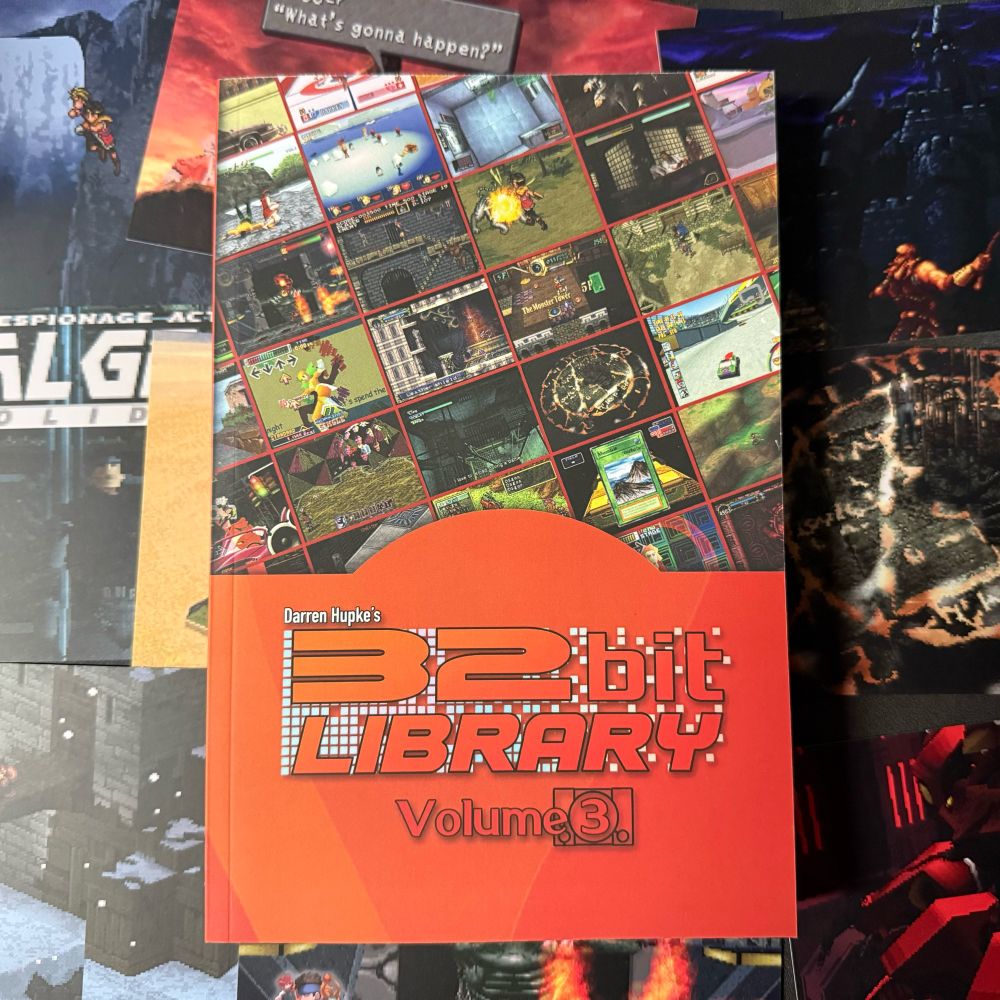 An orange paperback book with the title “32 Bit Library Volume 3” featuring a number of screenshots from various video games on the cover. Inside is written retrospectives for every game covered and bonus material from industry friends. 