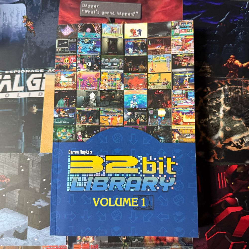 A blue paperback book with the title “32 Bit Library Volume 1” featuring a number of screenshots from various video games on the cover. Inside is written retrospectives for every game covered and bonus material from industry friends. 