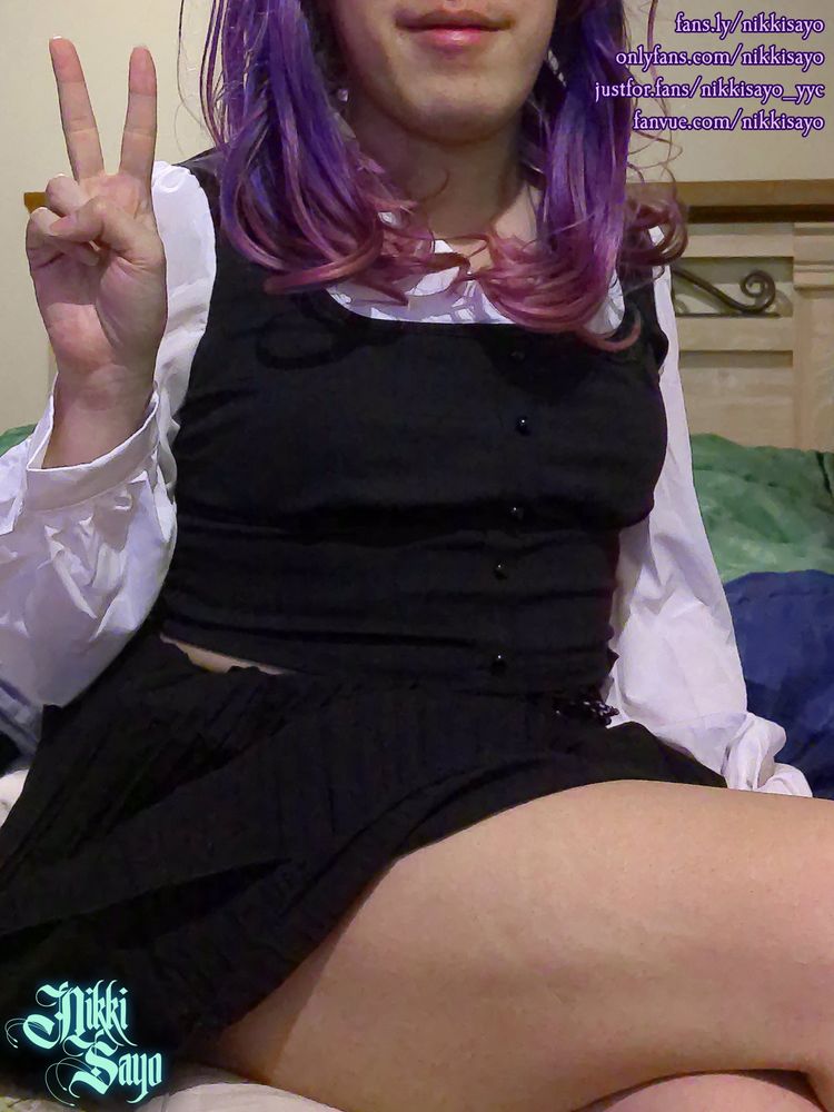 Purple haired femboy with a black/white fake vest top and a matching mid-length skirt