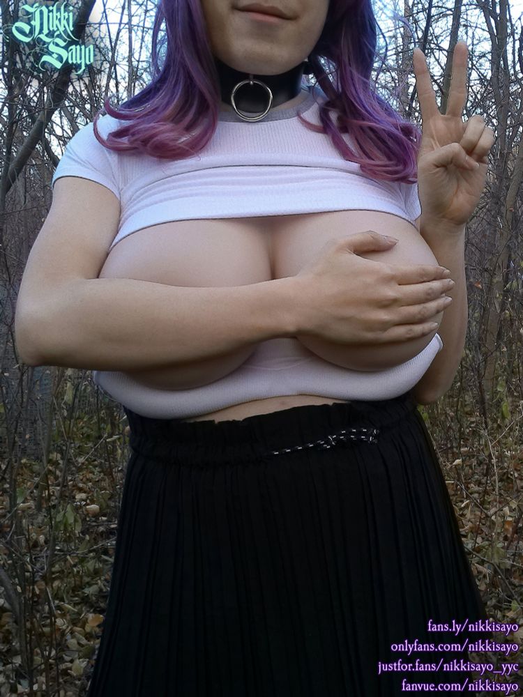 My shirt is lifted up proper while my bra is pulled down. While I cover my breasts with my right arm, my left arm holds up a peace sign.