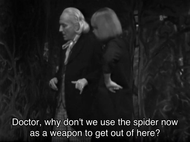 William Hartnell episode. The Doctor and Vicki are in some weird sort of organic room, with wavy lines and patterns on the walls. They’re both looking at something offscreen, hands on hips, thinking. Captions read, “Doctor, why don't we use the spider now as a weapon to get out of here?” “Because I think we might find it more valuable later on, child,”