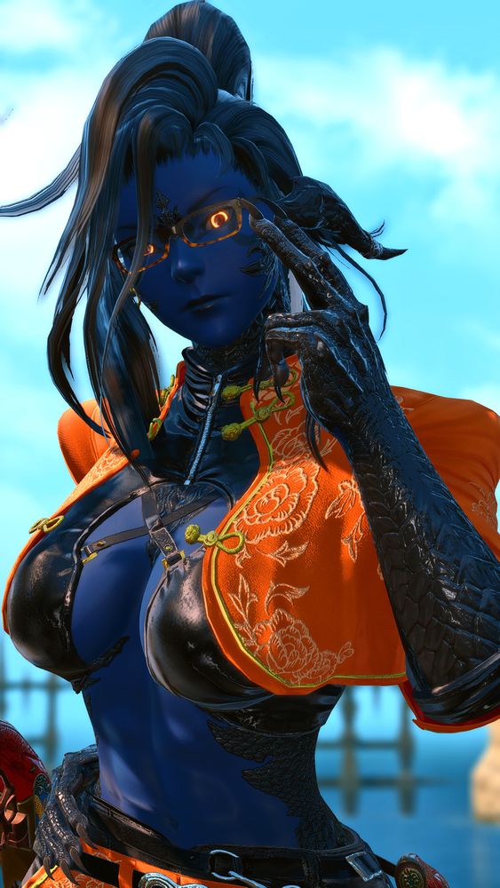 Khali leaning forward while adjusting her glasses.