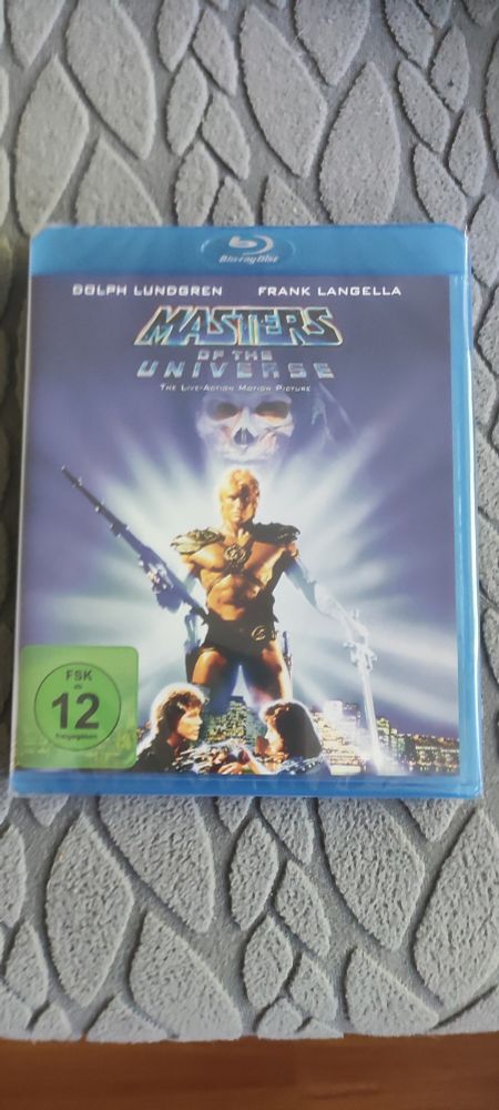 Cover der Blu Ray vom Realfilm zu Masters of the Universe. Mit FSK 12 Logo und Dolph Lundgren als He-Man mit Schwert.