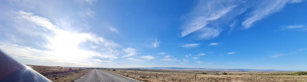 Big, beautiful blue sky, solitary rural road. A pause on a memorable road trip in 2022.